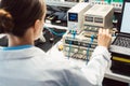 Engineer woman in electronics lab testing EMC compliance