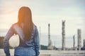 Engineer woman holding white helmet and blueprint with radio for workers security control at power plant energy industry. Royalty Free Stock Photo