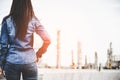 Engineer woman holding white helmet for workers security control at power plant energy industry. Petrochemicals Plant Background. Royalty Free Stock Photo