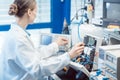 Engineer woman measuring electronic product on test bench