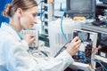 Engineer woman measuring electronic product on test bench Royalty Free Stock Photo