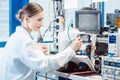 Engineer woman measuring electronic product on test bench Royalty Free Stock Photo