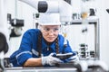 engineer woman worker working with robotic arm in productions lab research industry factory