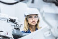 engineer woman worker working with robotic arm in productions lab research industry factory