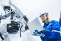 engineer woman worker working with robotic arm in productions lab research industry factory