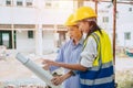 Engineer women builder working at construction site join architect teamwork looking at project floor plan Royalty Free Stock Photo