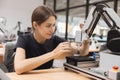 Engineer women learning education in Industrial Robotics program with robot arm simulation model in university engineering lab