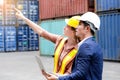 Engineer women point to container and control loading by using a computer Royalty Free Stock Photo