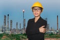 Engineer of women in smiling on oil refinery twilight background Royalty Free Stock Photo