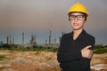Engineer of women in smiling on oil refinery twilight background Royalty Free Stock Photo