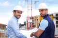 Engineer and worker checking plan on construction site Royalty Free Stock Photo