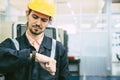 engineer worker looking at wristwatch. industry factory working hours afternoon break times for lunch Royalty Free Stock Photo