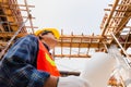 Engineer / worker man holding blueprint checking and planning project at construction site Royalty Free Stock Photo