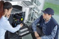 Engineer and worker trying to repair office printer Royalty Free Stock Photo