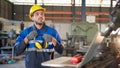 Engineer worker in uniform feeling tired and exhaust during work in front of machine in the factory. Put safety earmuff on machine Royalty Free Stock Photo