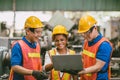 Engineer worker woman with male team working together Auditor in factory looking at Laptop computer happy smile Royalty Free Stock Photo