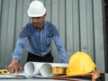 Engineer and workers discussing project of new building. architects Asian people on construction site check documents and business Royalty Free Stock Photo