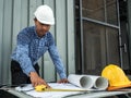 Engineer and workers discussing project of new building. architects Asian people on construction site check documents and business Royalty Free Stock Photo