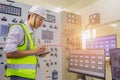 Engineer working on the checking status switchgear electrical energy distribution substation. Electrician and tool logging