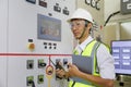 Engineer working on the checking status switchgear electrical energy distribution substation. Electrician and tool logging Royalty Free Stock Photo