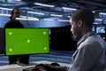 Engineer working at chroma key PC to prevent damages in server farm Royalty Free Stock Photo
