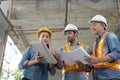 Engineer working at construction site meeting and discussing on laptop.