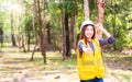 An engineer working in the forest. Forest worker supervisors are constructing roads in the forest. Woman showing thumbs up. Space