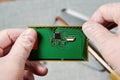 An engineer working on repairing a microchip in a tech laboratory