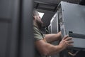 IT engineer working In the server room or data center The technician puts in a rack a new server of corporate business Royalty Free Stock Photo