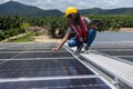 Engineer working setup Solar panel at the roof top. Engineer or worker work on solar panels or solar cells on the roof of business