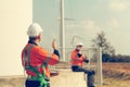 Engineer working at a wind farm for renewable energy has the responsibility of maintaining a sizable wind turbine. Encourage one Royalty Free Stock Photo