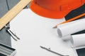 Engineer workplace with blueprints, compass, pencil and safety helmet. creative photo. Royalty Free Stock Photo