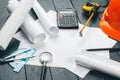 Engineer workplace with blueprints, compass, pencil and safety helmet. creative photo. Royalty Free Stock Photo