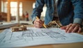 Engineer works on blueprint with model, construction concept. Architect design, project planning on construction site. Real Royalty Free Stock Photo