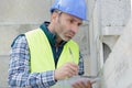 Engineer writes notes while inspecting construction site