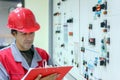 Engineer Writing on Clipboard in Power Plant Control Room Royalty Free Stock Photo