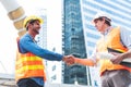 Engineer in Yellow helmet and best greeting with warm handshake manager visiting site. Modern construction and engineering concept Royalty Free Stock Photo