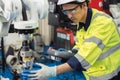 Engineer young man university student learn to control operate industry robot welding arm in robotics engineers lab classroom in