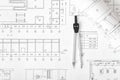 Engineering compass is on building plan. Royalty Free Stock Photo