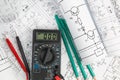 Engineering electronic drawings, pencils and digital multimeter Royalty Free Stock Photo