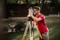 engineering equipment with theodolite and total station in a garden working on coordinates Royalty Free Stock Photo