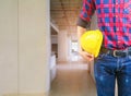 Engineering hand holding helmet yellow safety. check interior renovate house working construction site in building Royalty Free Stock Photo