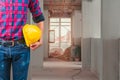 Engineering hand holding helmet yellow safety. check interior renovate house working construction site in building Royalty Free Stock Photo