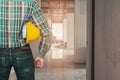 Engineering hand holding helmet yellow safety. check interior renovate house working construction site in building Tone Vintage Royalty Free Stock Photo