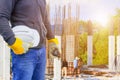 Engineering hand holding white safety hat interior working construction site in building Royalty Free Stock Photo