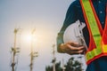 Engineering holds white safety hats and electric pole background