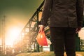 engineering man and safety helmet standing against beautiful light sun shine in heavey petrochemical industry estate Royalty Free Stock Photo