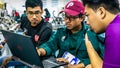 Engineering students discussing and solving the task given on the automation machine system in the laboratory Royalty Free Stock Photo