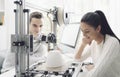 Engineering students using a 3D printer in the lab