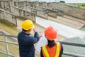 Engineering team Men and woman meeting with Engineers and supervisors are standing reading the blueprints at construction site